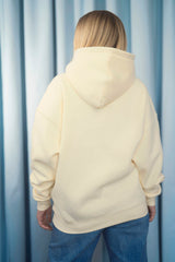 BUTTERMILK YELLOW Unisex Hoodie mit moderner, oversized Passform – kuschlig weich und aus hochwertigem Material.