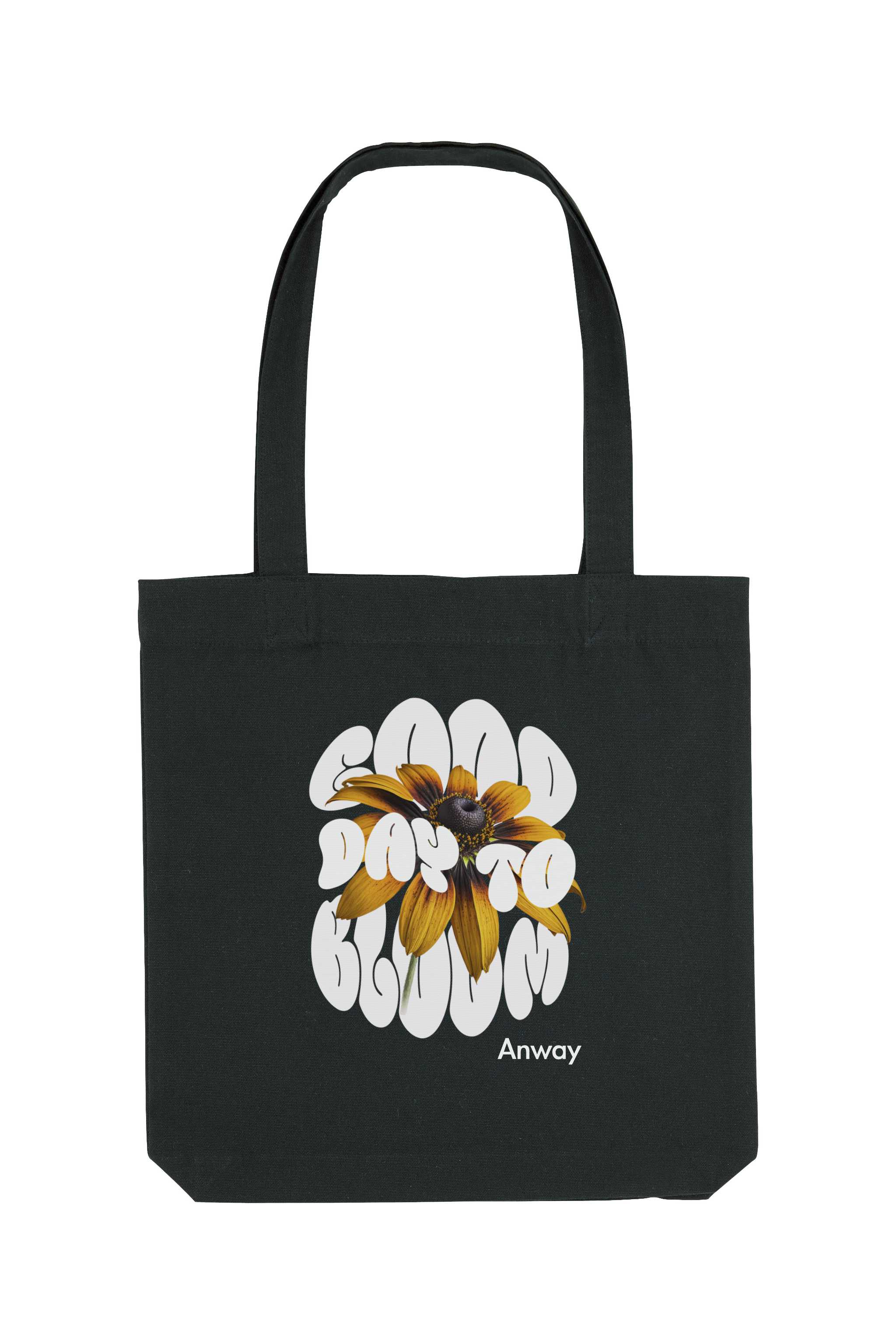 Schwarze Tote Bag mit dem weissen Schriftzug „GOOD DAY TO BLOOM“ im Retro-Stil, durchzogen von einer leuchtend gelben Sonnenblume – florales Statement-Piece mit positiver Botschaft.