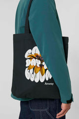 Schwarze Tote Bag mit dem weissen Schriftzug „GOOD DAY TO BLOOM“ im Retro-Stil, durchzogen von einer leuchtend gelben Sonnenblume – florales Statement-Piece mit positiver Botschaft.