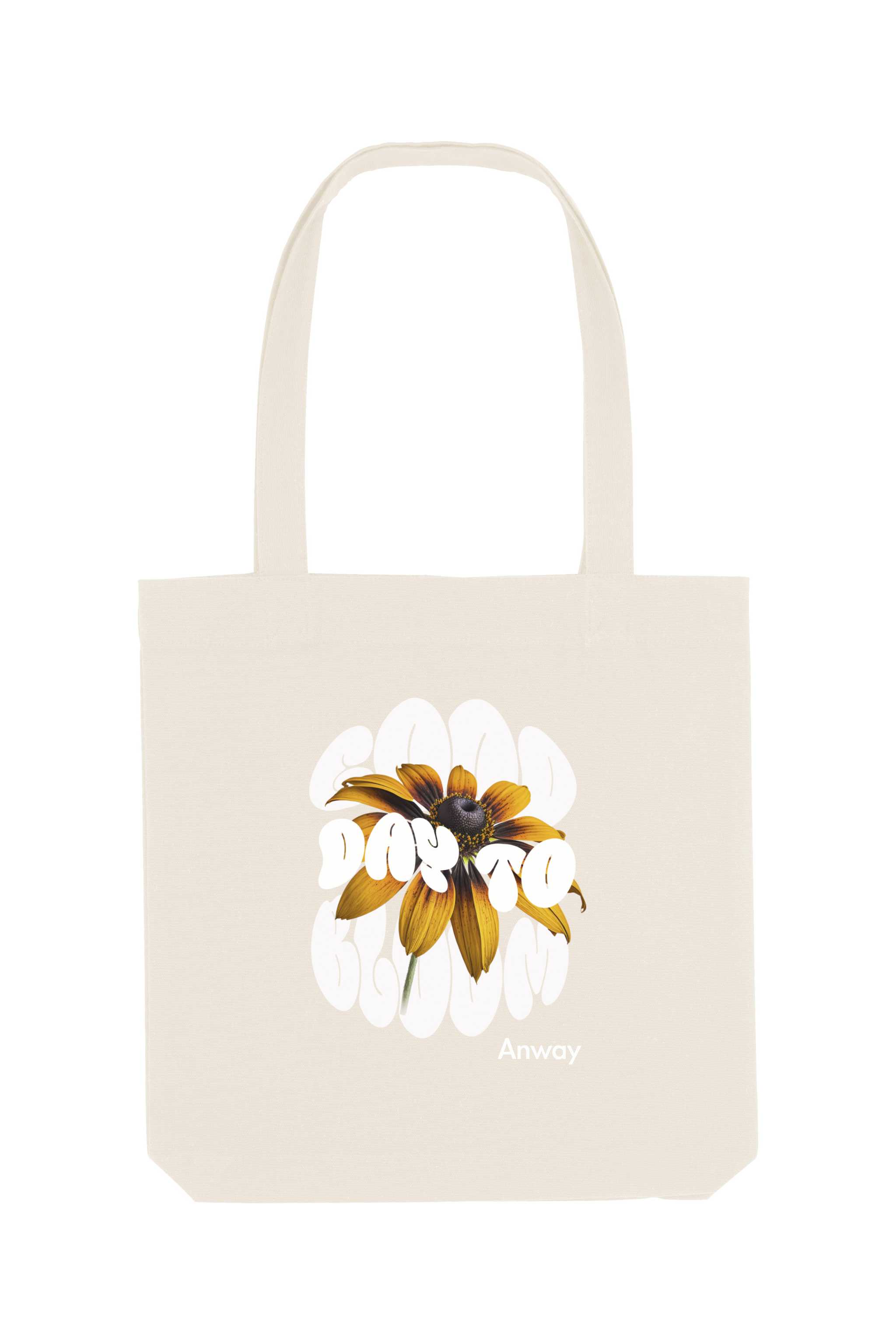 Naturfarbene Tote Bag mit dem weissem Schriftzug „GOOD DAY TO BLOOM“ im Retro-Stil, durchzogen von einer leuchtend gelben Sonnenblume – florales Statement-Piece mit positiver Botschaft.