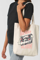 Naturfarbene Tote Bag mit retro-inspiriertem Design: Eine Kassette mit floralen Elementen, flankiert von zwei Sternen, und dem Schriftzug „ANWAY BLOOM“ in grossem rosa Vintage-Font – stylisch und nostalgisch zugleich.